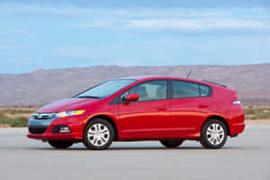 Honda Insight Hybrid Driving On A Road Wallpaper