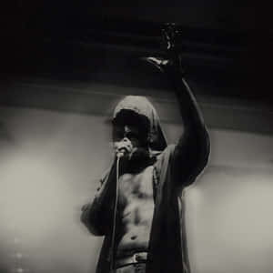 Hooded_ Performer_in_ Spotlight.jpg Wallpaper