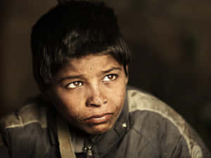 Hopeful Look Of A Poor Kid Wallpaper