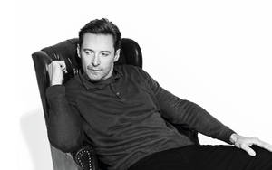 Hugh Jackman On Chair Grayscale Wallpaper