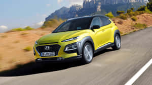 Hyundai Kona Driving Through A Picturesque Landscape Wallpaper