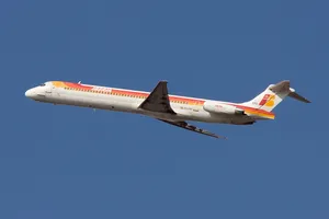 Iberia Airlines Airplane Flying In Plain Blue Sky Wallpaper