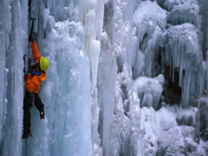 Ice Climber Ascending A Frozen Waterfall Wallpaper