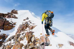 Ice Climber Scaling A Frozen Waterfall Wallpaper
