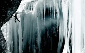 Ice Climber Scaling Impressive Frozen Waterfall Wallpaper
