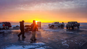 Ice Fishing Adventure On A Frozen Lake Wallpaper