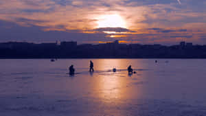 Ice Fishing Adventure On A Snowy Day Wallpaper