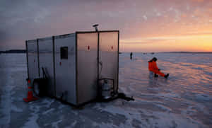 Ice Fishing On A Frozen Lake Wallpaper