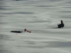 Ice Fishing On A Frozen Lake Wallpaper