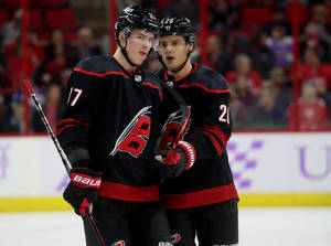 Ice Hockey Superstars Sebastian Aho And Andrei Svechnikov In Action Wallpaper