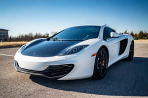 Iconic And Stock Mclaren Mp4-12c Racing On The Open Road Wallpaper