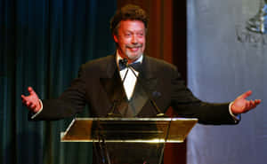 Iconic English Actor Tim Curry Captured In A Timeless Portrait Wallpaper