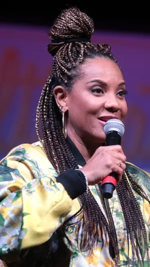 Iconic Female Rapper Speakingat Event.jpg Wallpaper