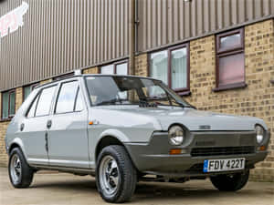 Iconic Fiat Ritmo Cruising Down The Road Wallpaper