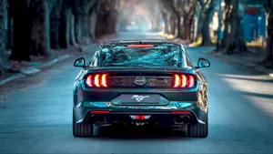 Iconic Ford Mustang Bullitt Cruising On The Highway Wallpaper