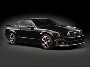 Iconic Ford Mustang Roush Showcasing Its Sleek Design And Power Wallpaper