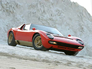 Iconic Lamborghini Miura Posing On A Scenic Road Wallpaper