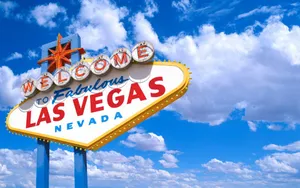 Iconic Las Vegas Strip Sign Against A Cloudy Sky Wallpaper