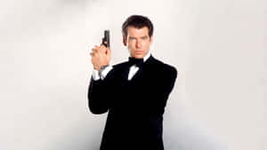 Iconic Spyin Tuxedo With Gun Wallpaper