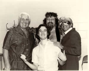 Iconic Wrestling Manager, Captain Lou Albano, In A Candid Shot With Fellow Management Professionals. Wallpaper