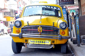 Iconic Yellow Cab Cruising Through The City Streets Wallpaper