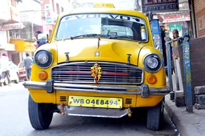 Iconic Yellow Cab Cruising Through The City Streets Wallpaper