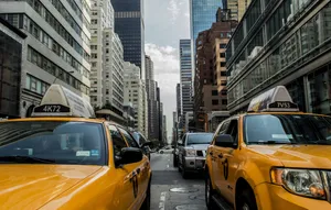Iconic Yellow Cab In The City Streets Wallpaper