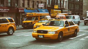 Iconic Yellow Cab In The City Streets Wallpaper