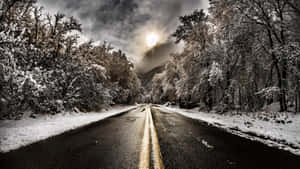 Icy Road In Winter Wonderland Wallpaper