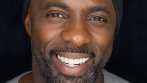 Idris Elba Smiling With Teeth Wallpaper