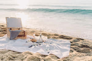 Idyllic Beach Picnic With Friends And Family Wallpaper