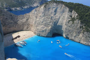 Idyllic Greek Island With Clear Blue Sea Wallpaper