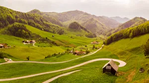 Idyllic Mountain Village Scenery Wallpaper