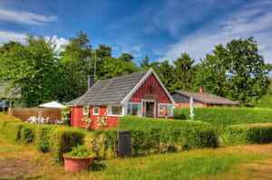 Idyllic Red Farmhouse Summer Setting Wallpaper