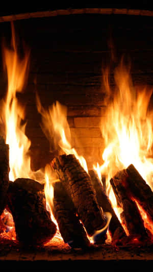 Ignite The Warmth - Cozy Fire In A Fireplace Wallpaper