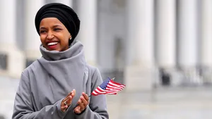 Ilhan Omar Holding A Tiny Flag Wallpaper