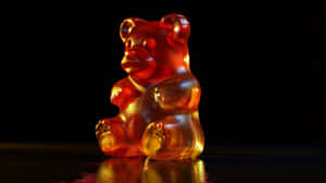 Illuminated Gummy Bearon Dark Background.jpg Wallpaper