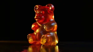Illuminated Gummy Bearon Dark Background.jpg Wallpaper