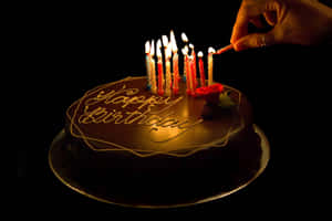 Illuminated Happy Birthday Cakewith Candles Wallpaper