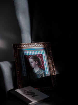 Illuminated Modernity: A Dark Vintage Portrait Wallpaper