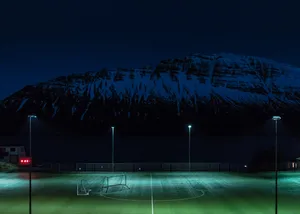 Illuminated Night Football Field Ready For The Game. Wallpaper