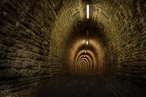 Illuminated Stone Tunnel Pathway Wallpaper