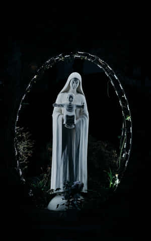 Illuminated Virgin Mary Statue Night Wallpaper