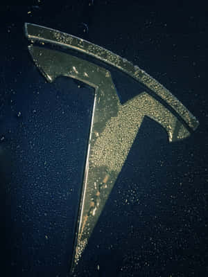 Image A Sleek Tesla Logo With Illuminated Lightning Bolts In 4k Resolution Wallpaper