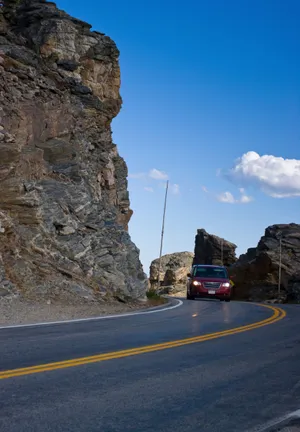 Image A Tranquil Lake Surrounded By Evergreen Trees And Mountain Peaks Wallpaper