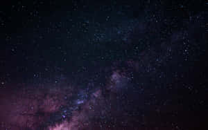 Image Fascinating View Of The Night Sky Above A Dark City Wallpaper