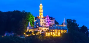Image Of A Beach At Twilight; Golden Hues Glimmer Against A Tranquil Blue Sea Wallpaper
