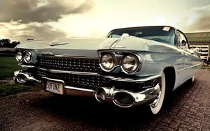 Immaculate Cadillac Deville On A Scenic Road Wallpaper