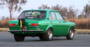 Immaculate Datsun 510 In A Radiant Sunset Scenery Wallpaper