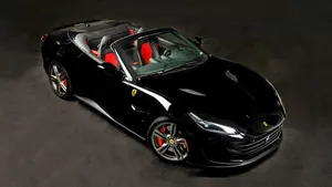 Impeccable Red Ferrari Portofino On A Stunning Coastal Road Wallpaper